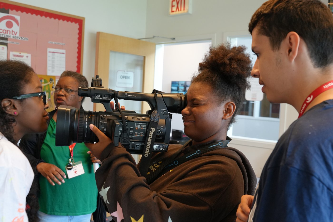 Young filmmakers working with a professional video camera at Free Spirit Media