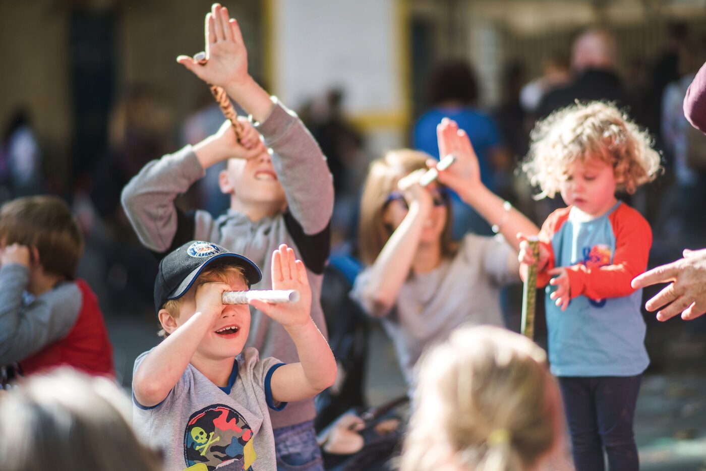 Children gathered around a creative workshop activity