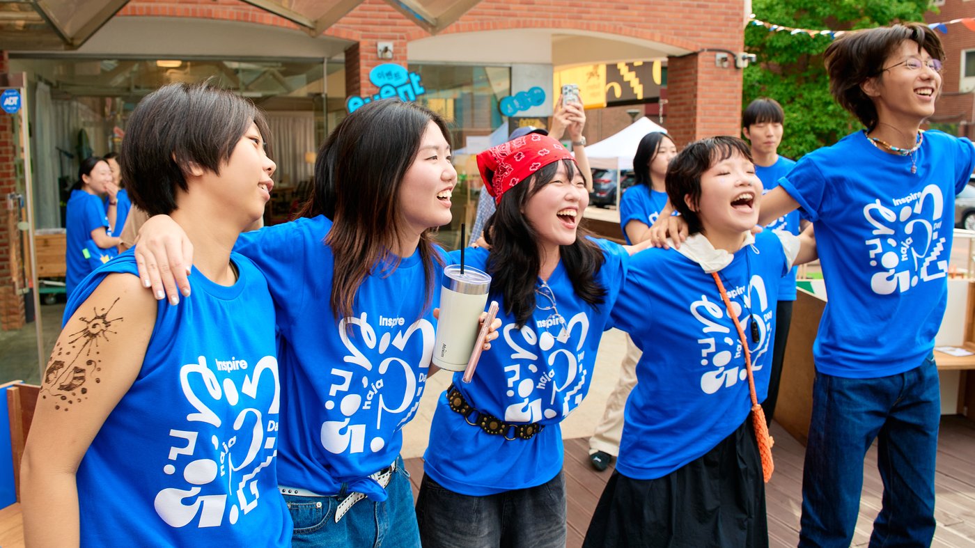 Young people laughing side by side at Haja Center